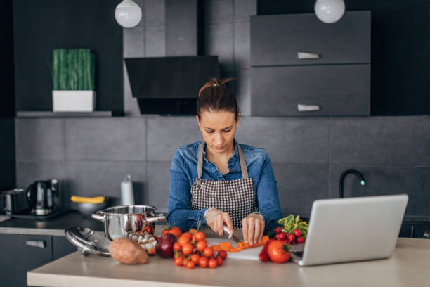 istock Woman making a meal in kitchen 1175485310