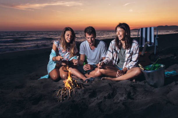 istock Happy friends partying on the beach with drinks 1175485828