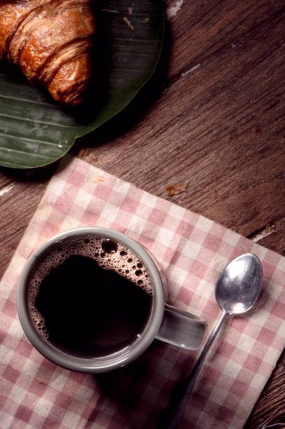 istock cup of coffee and croissant 1175485939