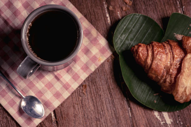 istock cup of coffee and croissant 1175487368