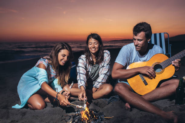 istock Happy friends partying on the beach with drinks 1175488303