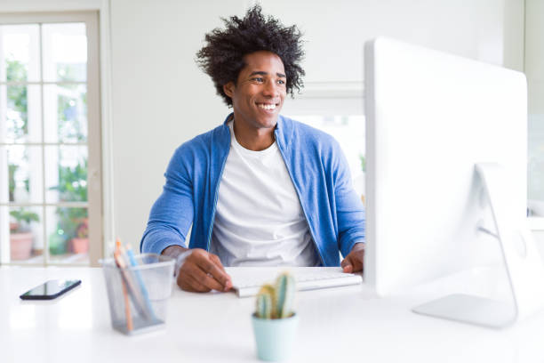 istock African American man working using computer with a happy face standing and smiling with a confident smile showing teeth 1175488917
