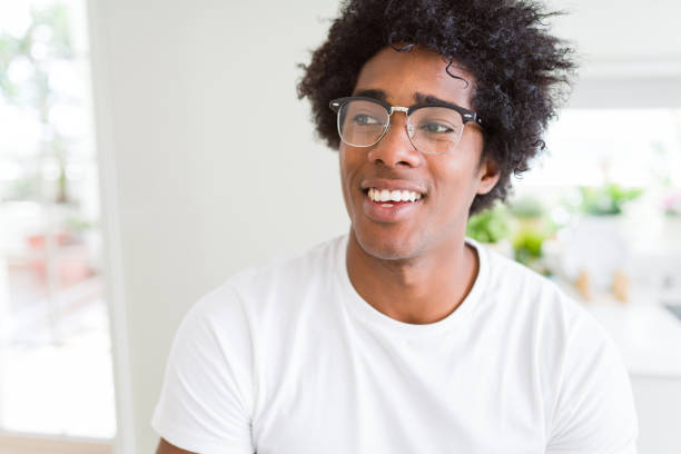 istock African American man wearing glasses smiling looking side and staring away thinking. 1175489176