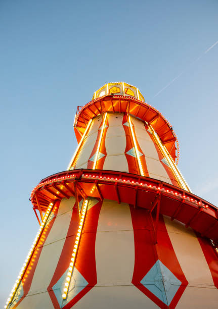 istock Red and white Fairground helter-skelter brightly lit at dusk 1175490082