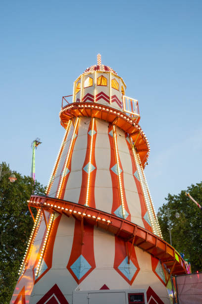 istock Red and white Fairground helter-skelter brightly lit at dusk 1175490102