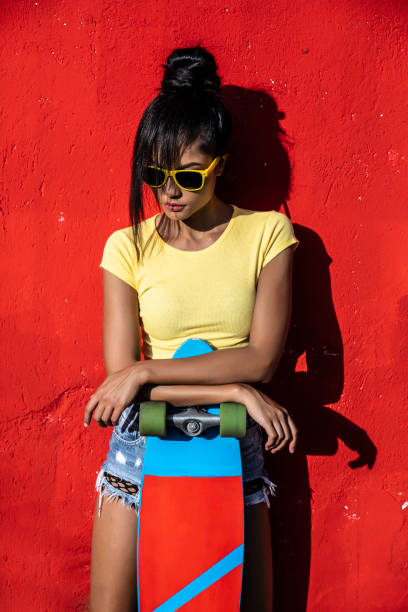 istock Woman holding scateboard 1175490158