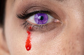 Female vampire crying blood from purple eye iris