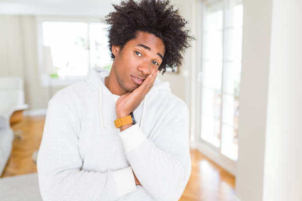 istock African American man wearing sweatshirt thinking looking tired and bored with depression problems with crossed arms. 1175492962