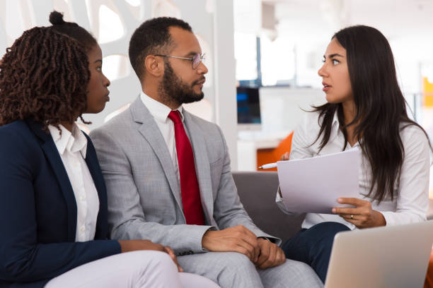 istock Shocked young female employee asking colleagues to help 1175493335