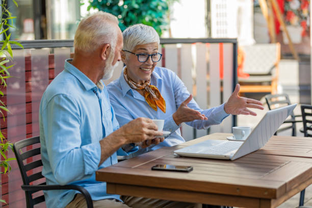 istock Senior Colleagues Sitting in Restaurant and Analyzing the Business 1175495983