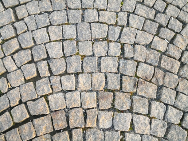 istock Abstract and background concept. Many small rough square stones, were arranged in curved lines to decorated the walkway. Selective focus and copyspace. 1175496175