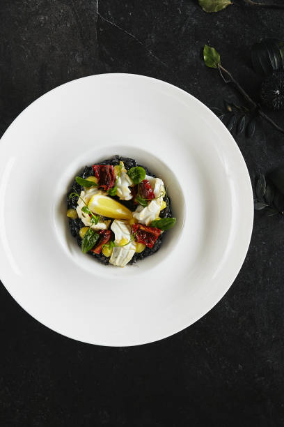istock Exquisite Serving White Restaurant Plate of Black Risotto with Octopus, Cuttlefish or Squid Meat Top View 1175497931