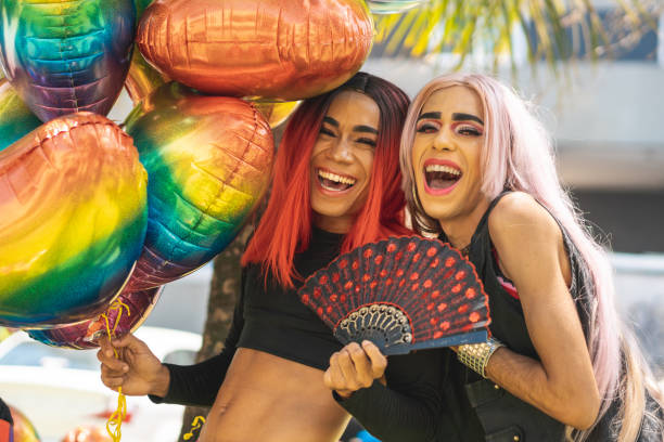 istock Drag queens laughing and holding colorful balloons 1175498026