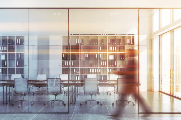 istock Man walking in white office with meeting room 1175498230