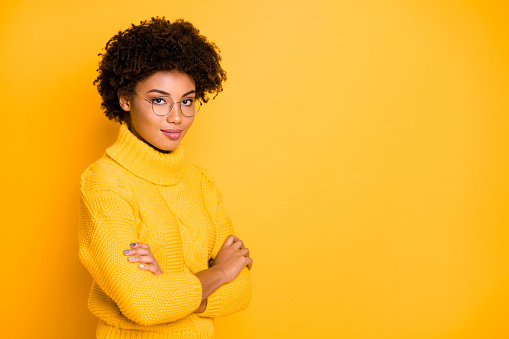 Close-up profile side view portrait of her she nice attractive lovely intellectual brainy, content wavy-haired girl folded arms isolated over bright vivid shine vibrant yellow color background