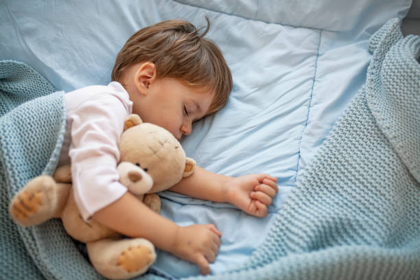 istock Baby toddler asleep with teddy bear 1175500142