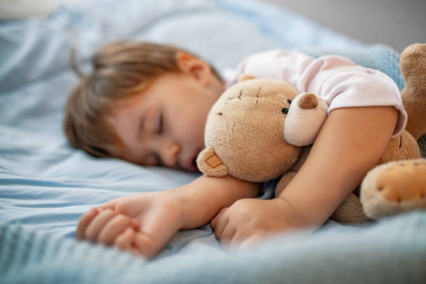 istock Baby toddler asleep with teddy bear 1175500731