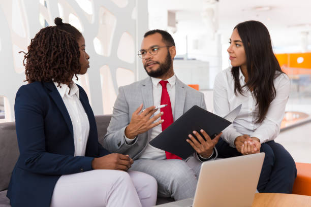 istock Legal expert explaining document details to colleagues 1175504679