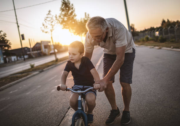 istock Grandfather teaching grandson biking 1175507737