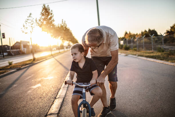 istock Grandfather teaching grandson biking 1175507855