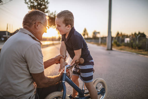 istock Grandfather teaching grandson biking 1175507876