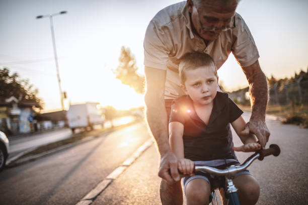 istock Grandfather teaching grandson biking 1175507970