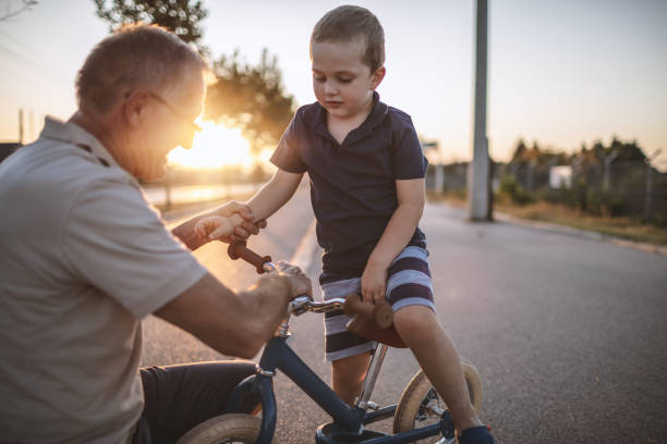 istock Grandfather teaching grandson biking 1175508162