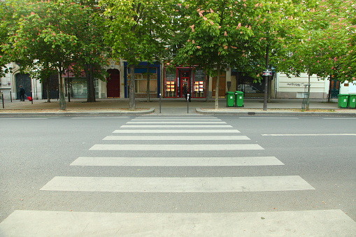 Large pedestrian crossing over a large and empty street in Paris, France