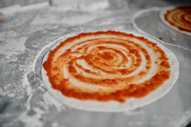 Cropped shot of a freshly made pizza base