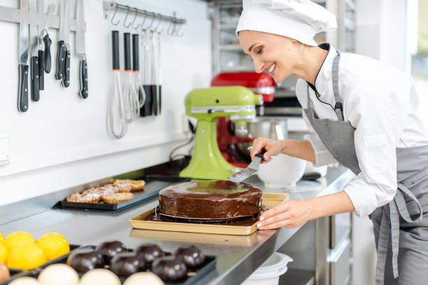 istock Patissier pouring liquid chocolate on a cake 1175510470