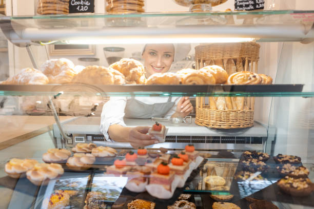 istock Confectioner shot through glass display in her shop 1175510644