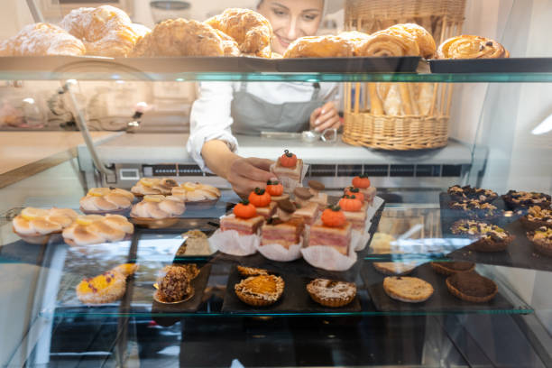 istock Confectioner shot through glass display in her shop 1175510847