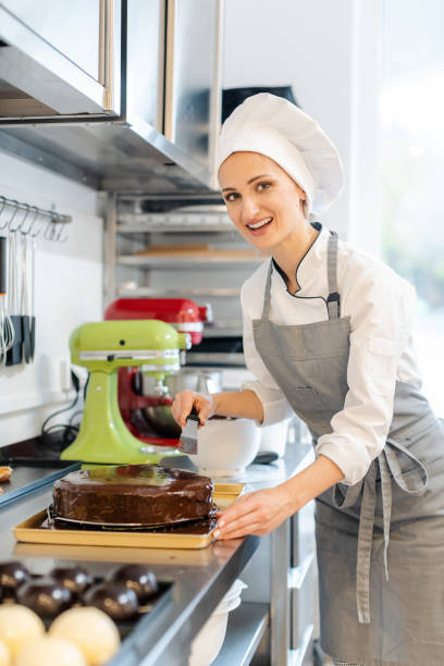 istock Patissier pouring liquid chocolate on a cake 1175510850