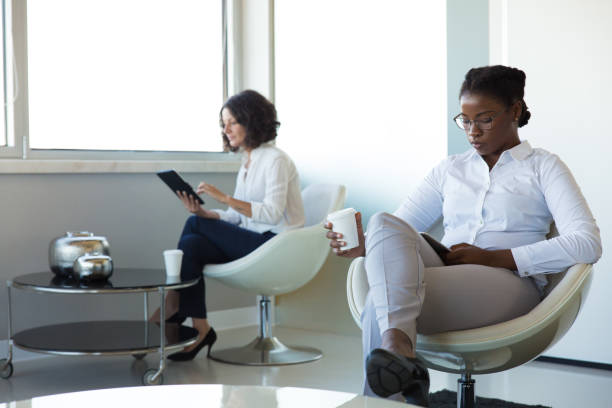 istock Businesswomen using gadgets during coffee break 1175510913
