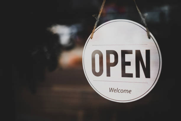istock Open sign hanging front of cafe with colorful bokeh light abstract background. 1175512655