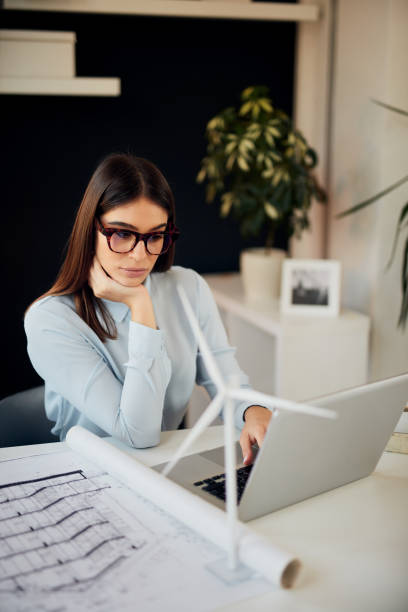 istock Businesswoman using laptop in office. Sustainable development concept. 1175514041
