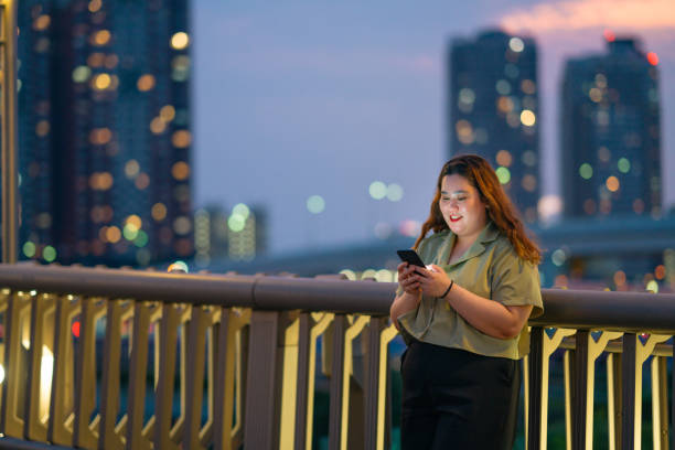 istock Young woman using smart phone at night 1175519214