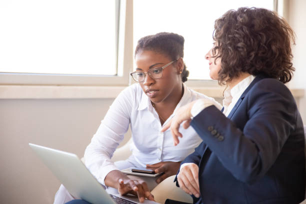istock Female business colleagues discussing project 1175520515