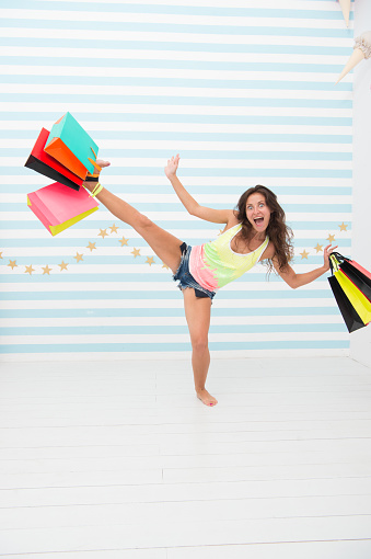 shopping hunter girl with purchase after big sale. happy and excited woman with shopping bags. black friday sale in shop. happy girl with presents. Crazy shopaholic. Carefree fun