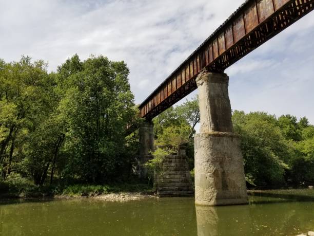 istock Train railway bridge suspended on concrete tower over river 1175524907