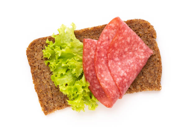 istock Sandwich with salami sausage on white background. 1175525485