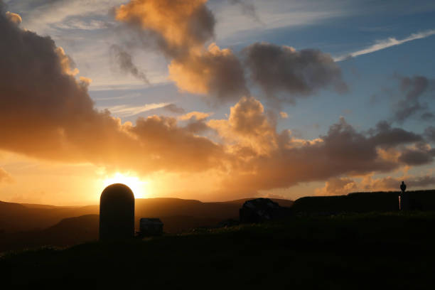 istock Cemetery Tombstone Silhouette Sunset Landscape 1175525489