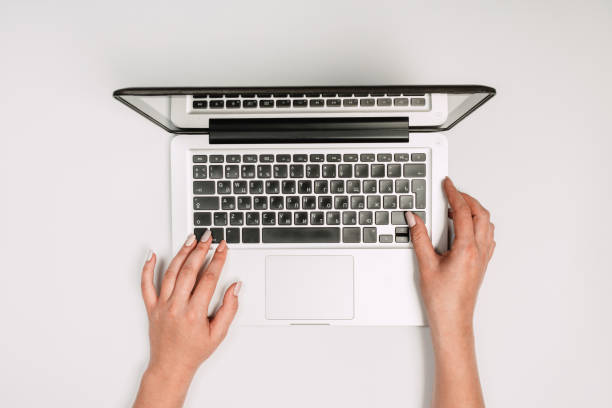 istock Modern workspace with woman hands and laptop copy space on white color background. Top view. Flat lay style. 1175526408