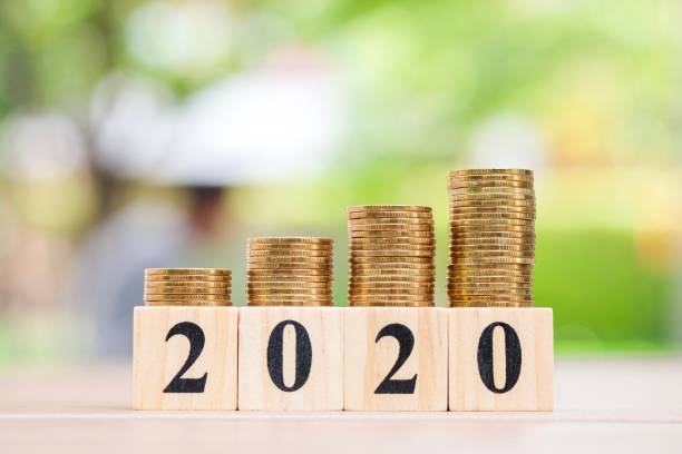 Growth of coins stack and wood blocks number 2020.