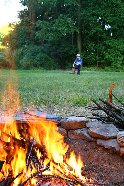 istock Fire Danger: Toddler Boy too close to summer Bonfire 117552971