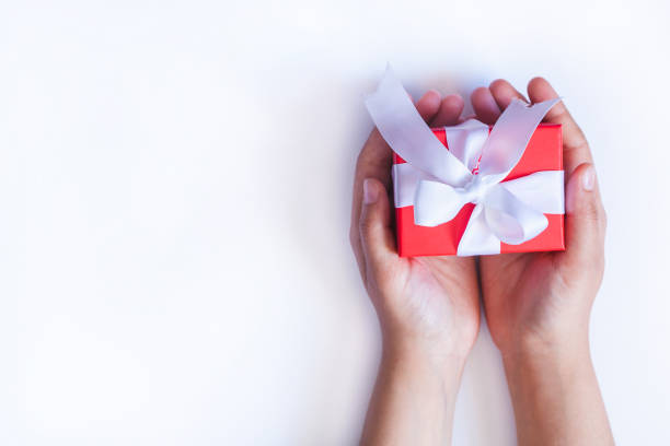 istock Gift in female hands. Woman hands holding a giftbox, present or surprise 1175530066