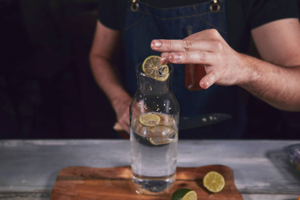 istock Young chef in kitchen squeeze orange and lime for juice. Food concept. 1175532593