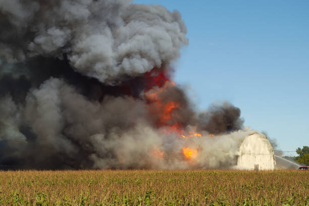 smoke fire explosion flame farm destruction disaster stock photo