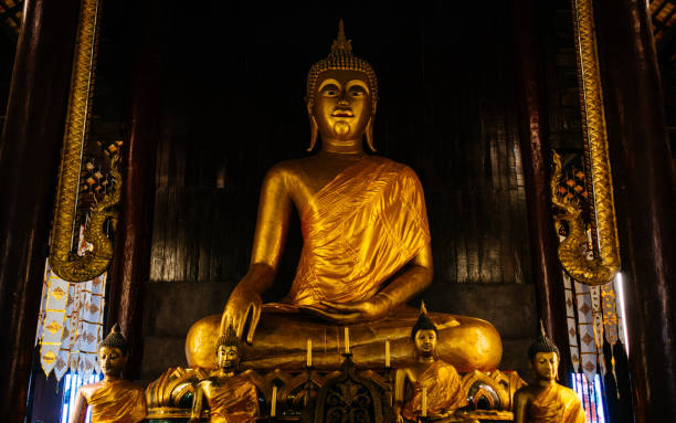 istock Wat chedi luang, monks praying inside a temple 1175547762