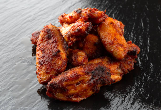 istock Fried wings close-up. Buffalo wings on a slate surface. 1175548870